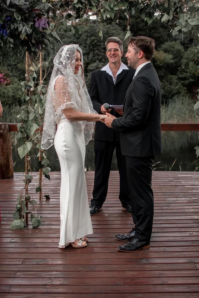 Couple holding hands during their vows